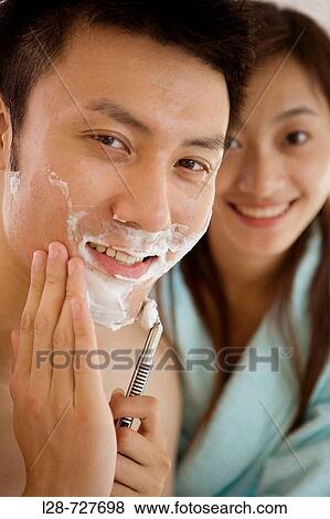 Young woman shaving young man, smiling, close-up View Large Photo Image Stock Photo - Young woman shaving young man, smiling, close-up. Fotosearch