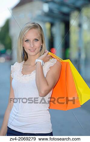 Young woman shopping in a town outdoors. View Large Photo Image Stock Photo - Young woman shopping in a town outdoors.. Fotosearch
