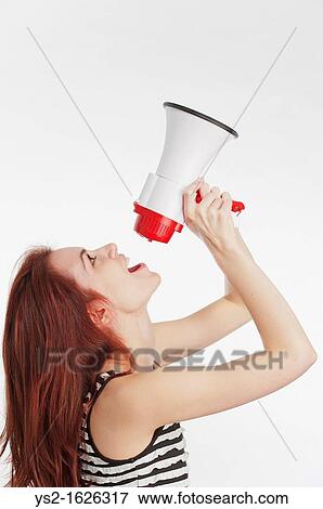 Young woman shouting in a megaphone View Large Photo Image Stock Photo - Young woman shouting in a megaphone. Fotosearch