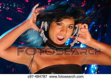Stock Photo - Young woman singing headphones on.. Fotosearch