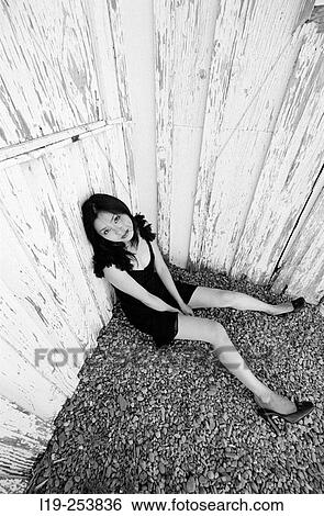 Young woman sitting alone View Large Photo Image Stock Photograph - Young woman sitting alone. Fotosearch