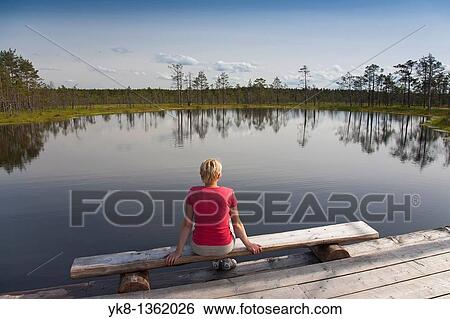 Young Woman Sitting by Bog Lake in Viru Bog, L??ne-Viru County, Estonia, Europe View Large Photo Image Stock Photograph - Young Woman Sitting by Bog Lake in Viru Bog, L??ne-Viru County, Estonia, Europe. Fotosearch