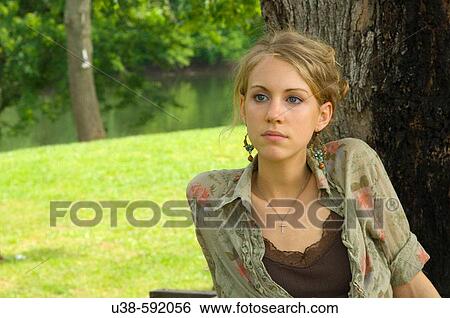 Stock Photograph - Young woman sitting for a portrait. Fotosearch