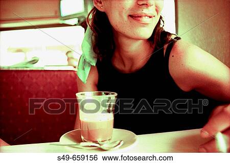 Young woman sitting in a bar View Large Photo Image Stock Photograph - Young woman sitting in a bar. Fotosearch