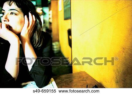 Young woman sitting in a bar View Large Photo Image Stock Photography - Young woman sitting in a bar. Fotosearch