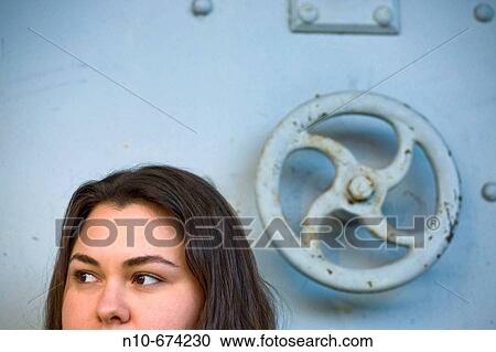 Young woman sitting in front of a vault. View Large Photo Image Stock Image - Young woman sitting in front of a vault.. Fotosearch