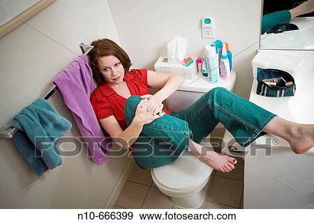 Young woman sitting in her bathroom. View Large Photo Image Stock Photo - Young woman sitting in her bathroom.. Fotosearch