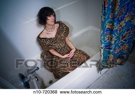 Young woman sitting in her bathtub. View Large Photo Image Stock Photo - Young woman sitting in her bathtub.. Fotosearch
