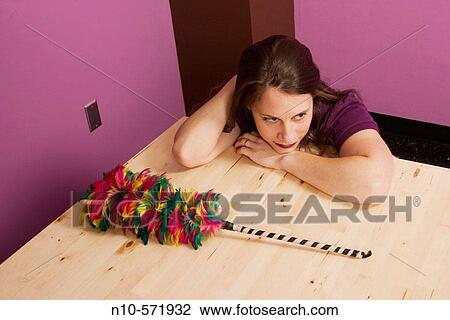 Young woman sitting next to a feather duster View Large Photo Image Stock Image - Young woman sitting next to a feather duster. Fotosearch