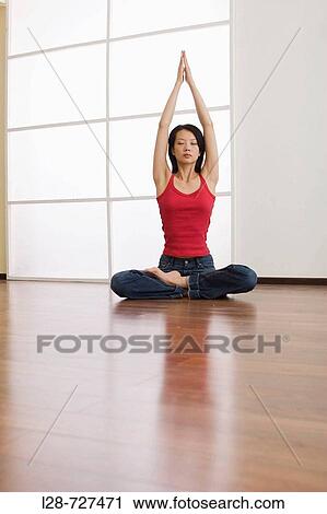 Young woman sitting on floor, hands in prayer position above head View Large Photo Image Stock Image - Young woman sitting on floor, hands in prayer position above head. Fotosearch