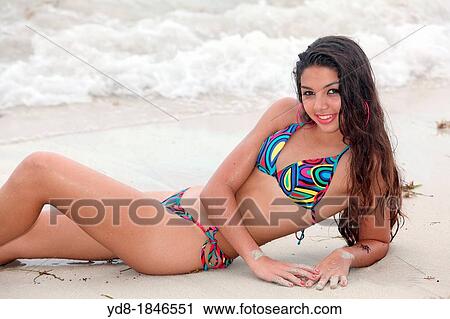 Young woman sitting on the sand posing smailing, Miami Beach, Florida, USA View Large Photo Image Stock Image - Young woman sitting on the sand posing smailing, Miami Beach, Florida, USA. Fotosearch