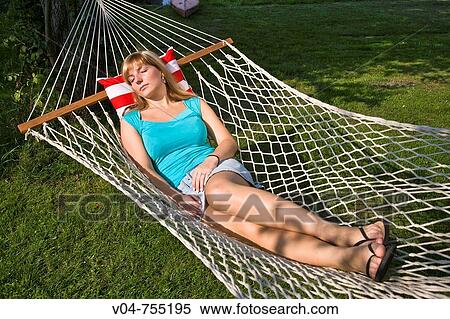 Young woman sleeping in a hammock in the garden View Large Photo Image Stock Photography - Young woman sleeping in a hammock in the garden. Fotosearch
