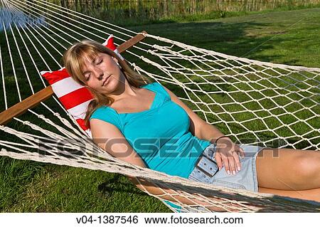 Young woman sleeping in a hammock, Germany, Europe View Large Photo Image Stock Photograph - Young woman sleeping in a hammock, Germany, Europe. Fotosearch