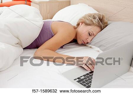 Young woman sleeping while communicating on her laptop View Large Photo Image Stock Image - Young woman sleeping while communicating on her laptop. Fotosearch