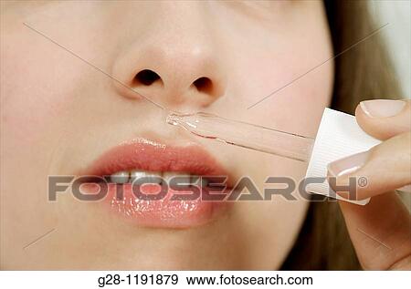 Young woman smelling essential oils with a pipette under her nose close up View Large Photo Image Stock Photo - Young woman smelling essential oils with a pipette under her nose close up. Fotosearch