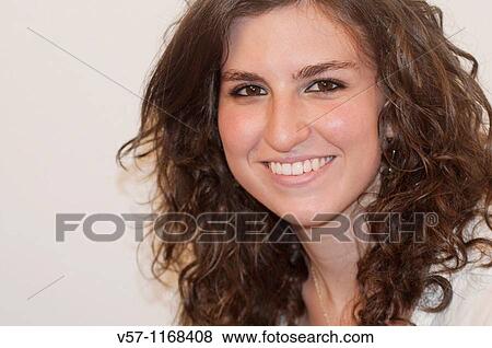 Young woman smiling and looking at the camera. Close view. View Large Photo Image Stock Photo - Young woman smiling and looking at the camera. Close view.. Fotosearch