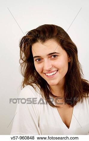 Young woman smiling and looking at the camera View Large Photo Image Stock Photo - Young woman smiling and looking at the camera. Fotosearch