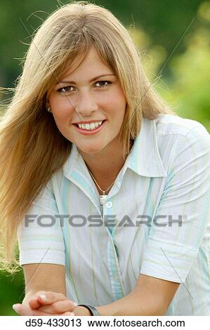 Young woman smiling at camera View Large Photo Image Stock Image - Young woman smiling at camera. Fotosearch