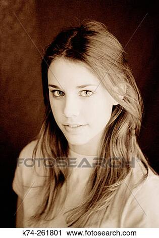 Young woman smiling at camera View Large Photo Image Stock Image - Young woman smiling at camera. Fotosearch