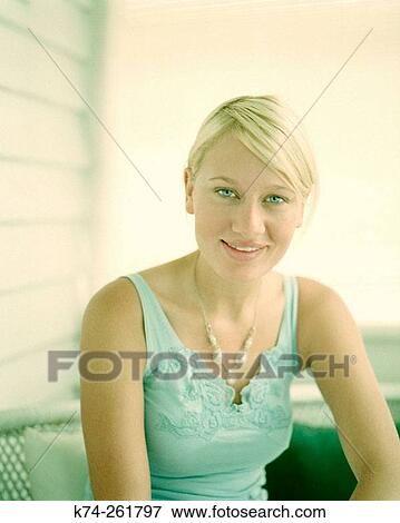 Stock Photo - Young woman smiling at camera. Fotosearch
