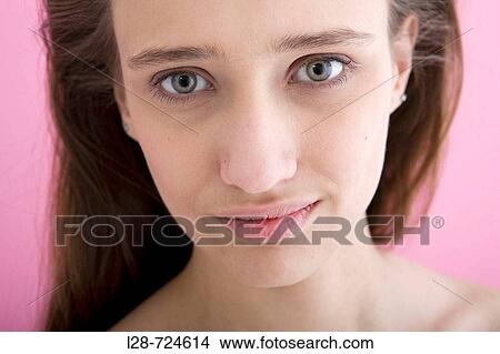 Picture - Young woman smiling, portrait, close-up, studio shot, pink background. Fotosearch