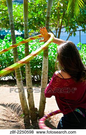 Young woman spinning her hula-hoops at The Organic Fair in Amon. View Large Photo Image Stock Photo - Young woman spinning her hula-hoops at The Organic Fair in Amon.. Fotosearch