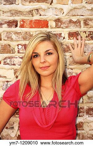Young Woman Standing Against Brick Wall - Nederland, Jefferson County, Texas View Large Photo Image Stock Image - Young Woman Standing Against Brick Wall - Nederland, Jefferson County, Texas. Fotosearch