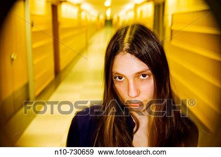 Young woman standing in an office building hallway. View Large Photo Image Stock Photo - Young woman standing in an office building hallway.. Fotosearch