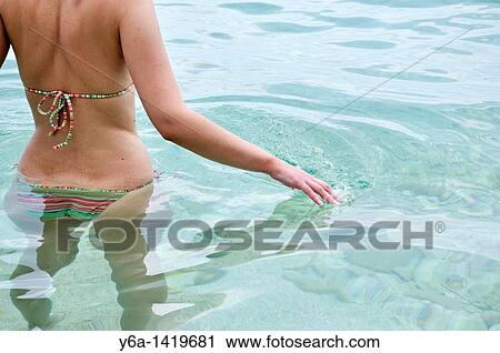 Young woman standing in ocean View Large Photo Image Stock Image - Young woman standing in ocean. Fotosearch