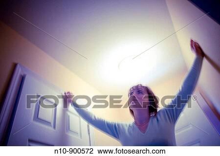 Young woman standing in the hallway of her house. View Large Photo Image Stock Image - Young woman standing in the hallway of her house.. Fotosearch