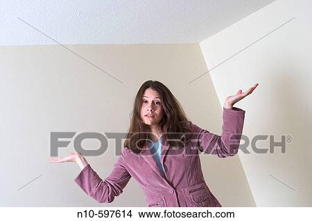 Young woman standing on her bed with her arms extended out View Large Photo Image Picture - Young woman standing on her bed with her arms extended out. Fotosearch