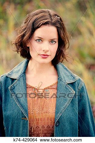 Picture - Young Woman Standing Outside In Field. Fotosearch