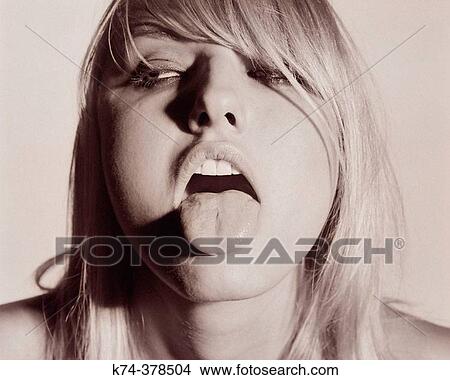 Picture - Young woman sticking out her tongue. Fotosearch