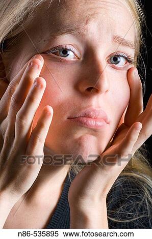 Young woman stretching out eye wrinkles View Large Photo Image Stock Photography - Young woman stretching out eye wrinkles. Fotosearch
