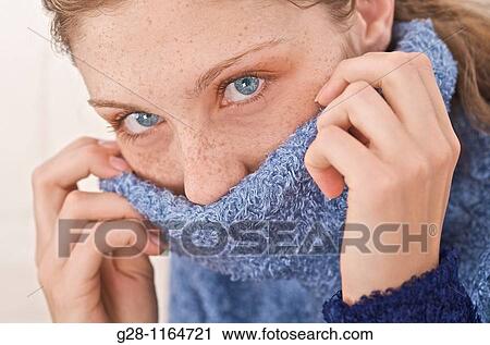 Young woman suffering from a sore throat and hiding in her sweater collar View Large Photo Image Stock Image - Young woman suffering from a sore throat and hiding in her sweater collar. Fotosearch