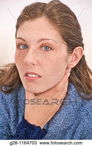 young woman suffering from a sore throat View Large Photo Image Stock Image - young woman suffering from a sore throat. Fotosearch
