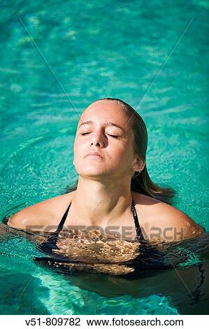 Young woman swimming in the pool View Large Photo Image Stock Image - Young woman swimming in the pool. Fotosearch