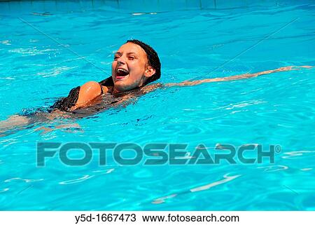 young woman swimming in the water, swimming pool, summer, fun View Large Photo Image Stock Image - young woman swimming in the water, swimming pool, summer, fun. Fotosearch