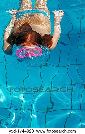 young woman swimming under water in the swimming pool View Large Photo Image Stock Image - young woman swimming under water in the swimming pool. Fotosearch
