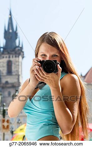 Young woman taking pictures in Old Town Square of Prague, Czech Republic View Large Photo Image Stock Photograph - Young woman taking pictures in Old Town Square of Prague, Czech Republic. Fotosearch