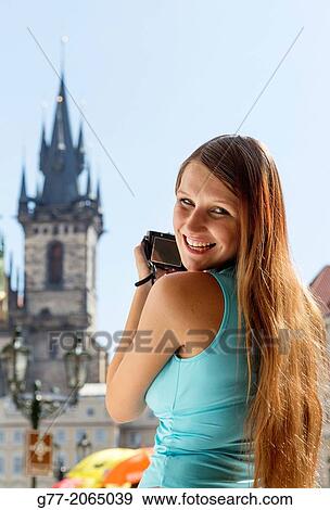 Young woman taking pictures of the Church of Our Lady of Tyn in Prague. Czech Republic. Prague. View Large Photo Image Stock Photo - Young woman taking pictures of the Church of Our Lady of Tyn in Prague. Czech Republic. Prague.. Fotosearch