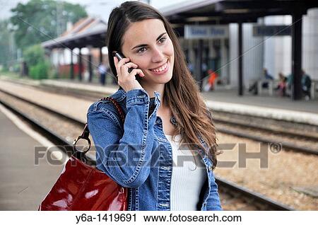 Young woman talking on cell phone View Large Photo Image Stock Image - Young woman talking on cell phone. Fotosearch