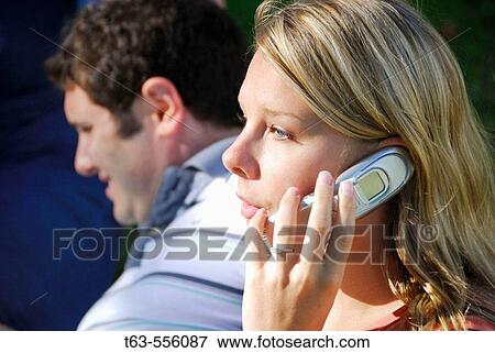 Stock Photo - young woman talking on cell phone. Fotosearch