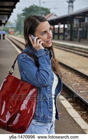 Young woman talking on cell phone View Large Photo Image Stock Photograph - Young woman talking on cell phone. Fotosearch