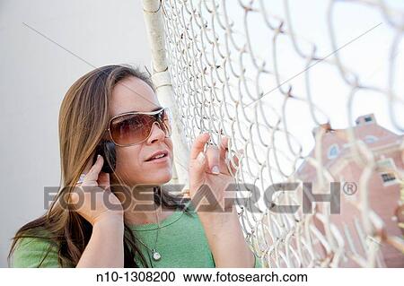 Stock Image - Young woman talking on her cell phone. Fotosearch