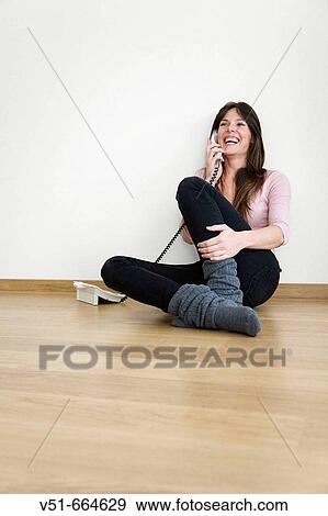 Young woman talking on the phone at home. View Large Photo Image Stock Photo - Young woman talking on the phone at home.. Fotosearch