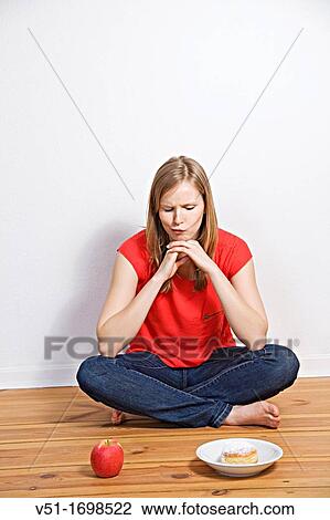 Young woman tempted to eat healthy or unhealthy View Large Photo Image Stock Image - Young woman tempted to eat healthy or unhealthy. Fotosearch