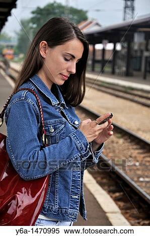 Young woman text messaging View Large Photo Image Stock Photography - Young woman text messaging. Fotosearch