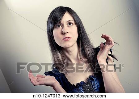 Stock Image - Young woman thinking. Fotosearch