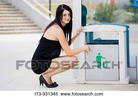 Young woman, trash can View Large Photo Image Stock Photography - Young woman, trash can. Fotosearch